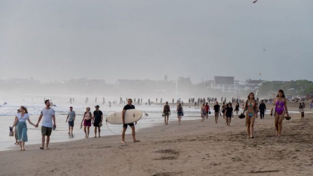 BALI, INDONESIA - 2022/09/17: Large crowds of tourists and expats are seen at Seminyak Beach. Tourism in Indonesia is picking up after the covid 19 pandemic.