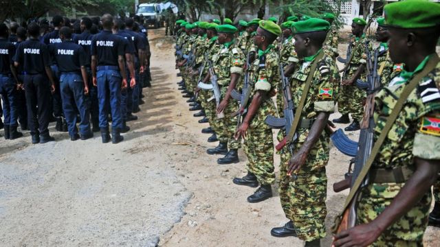 Burundian peacekeepers in attention as Somali police officers go on parade