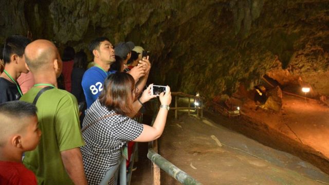 People take photographs at the entrance of the Tham Luang cave in Mae Sai district, Chiang Rai province, Thailand, on 01 November 2019.