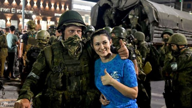 Woman poses for picture with Wagner Group troop