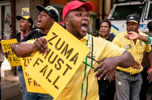 Supporters of the African National Congress Deputy President Cyril Ramaphosa hold placards and chant slogans outside the ANC party headquarter in Johannesburg, on February 5, 2018, during a demonstration to protest against South African President and ANC member Jacob Zuma. Senior members of South Africa's ANC party will hold an emergency meeting Monday to discuss whether President Jacob Zuma should stay in office after he reportedly refused to resign. Some African National Congress (ANC) members are pushing for Cyril Ramaphosa, the new head of the party, to replace Zuma as president immediately.