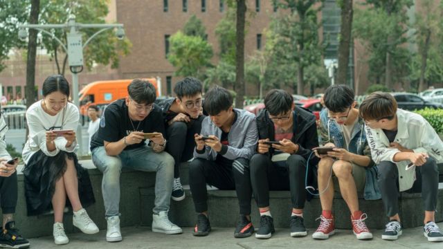 Chinese young people playing with mobile phones