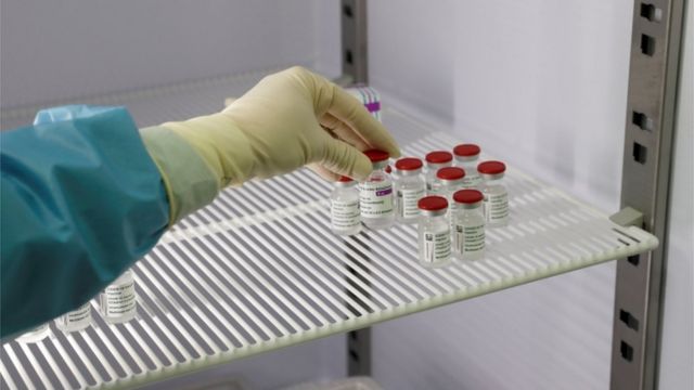 A medical worker in Italy holds a vial of the Oxford-AstraZeneca vaccine