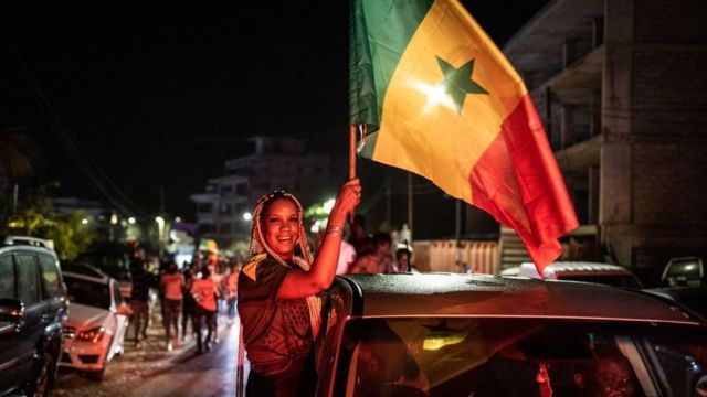 Des supporters célèbrent à Dakar le 06 janvier 2022, après la victoire du Sénégal en finale de la Coupe d'Afrique des Nations (CAN) contre l'Egypte à Yaoundé, au Cameroun..