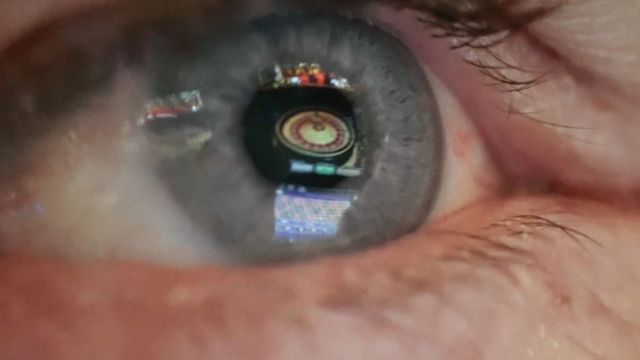 an eye reflecting a roulette wheel