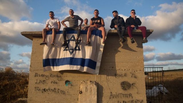 Israelis gather to watch the Iron Dome missile defence system launch to intercept rockets fire from the Gaza Strip