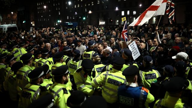 Demonstrators clash with police officers during a pro Brexit rally in Parliament Square