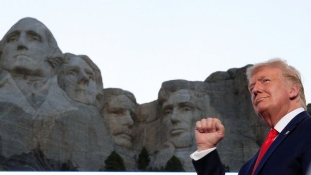 President Trump stands in front of Mount Rushmore