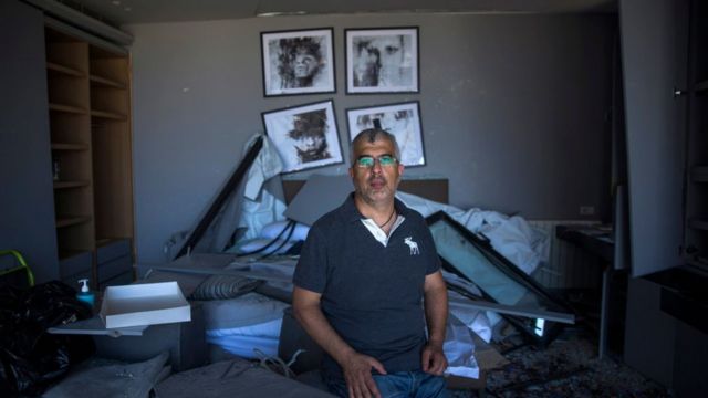 A man sits in his house the day after the explosion