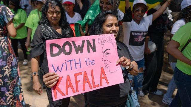 Mujeres protestando en Líbano con un cartel que dice "abajo el kafala". 2019