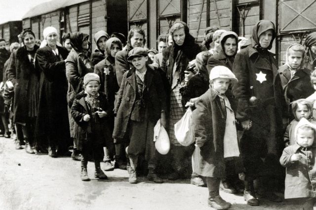 Jews next to the trains where they were sent to the concentration camps.