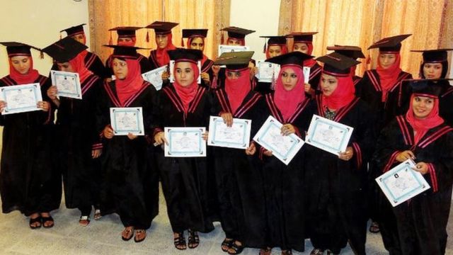 Afghan nurses showing their graduation certificate