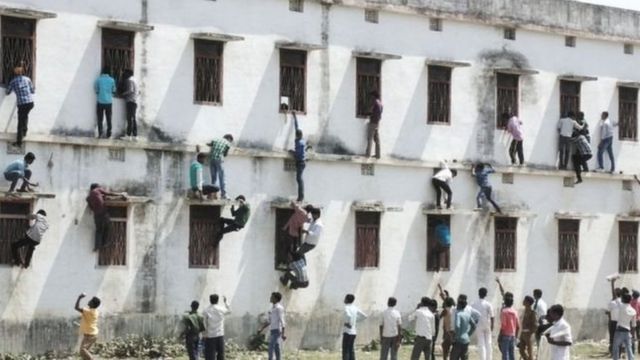En 2016, des parents d'élèves ont été photographiés en train de grimper sur les murs d'une école pour transmettre des réponses à des élèves, lors d'un examen scolaire, au Bihar.