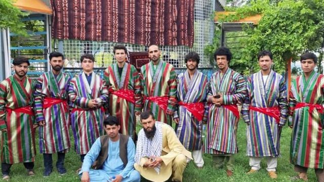 Talibshah Hosseini standing in the centre after a performance for farmer's day in Faryab Province