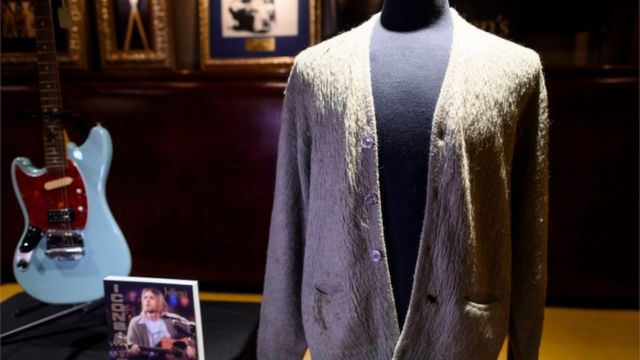 Kurt Cobain's iconic mohair green cardigan and his Fender Mustang guitar, sold at auction in New York in October 2019