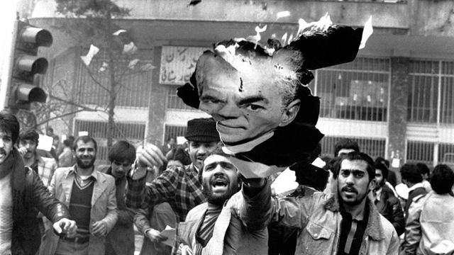 Protesters in Iran burn an image of the shah in 1978.