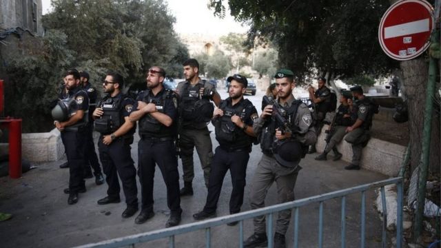 Israeli security forces hold a position as Palestinian Muslim worshippers gather to pray outside Jerusalem's Old City on 25 July 2017
