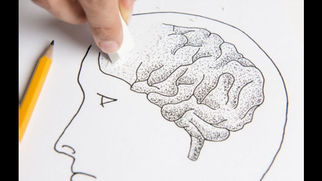Foto de uma pessoa apagando o desenho de um cérebro