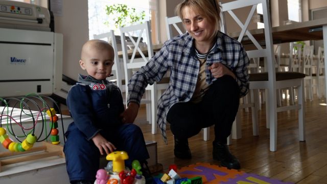 Pavlo plays with his mother Lesia.