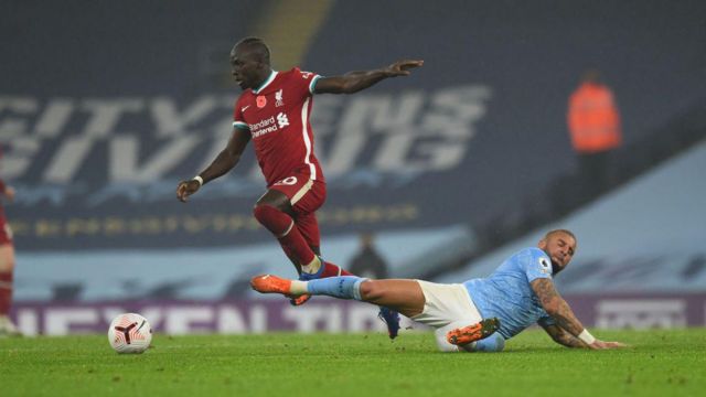 Sadio Mane of Liverpool is challenged by Kyle Walker of Manchester City