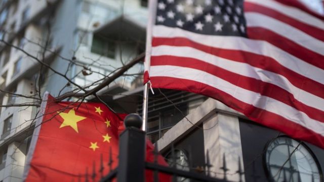 US and China flags together outside an international school in Beijing