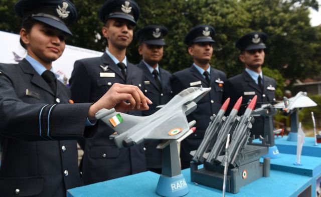 Members of the Air Force contingent pose with a mockup of the Indian Air Force tableaux for the Republic Day Parade featuring the Rafale fighter jet.