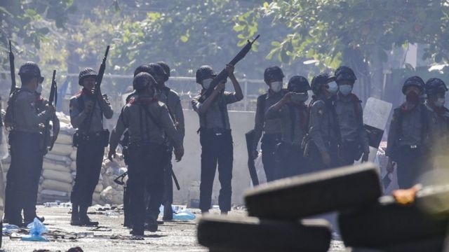 Police officers search for hiding demonstrators