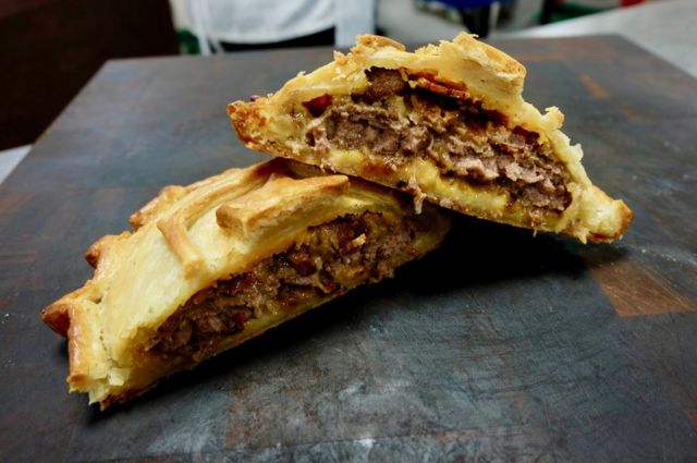 A close up of a cheese burger pie