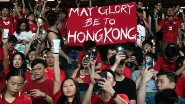 Football fans hold up a banner as they take part in a protest during half time in the World Cup qualifying match between Hong Kong and Iran at Hong Kong Stadium on September 10, 2019 in Hong Kong, China.