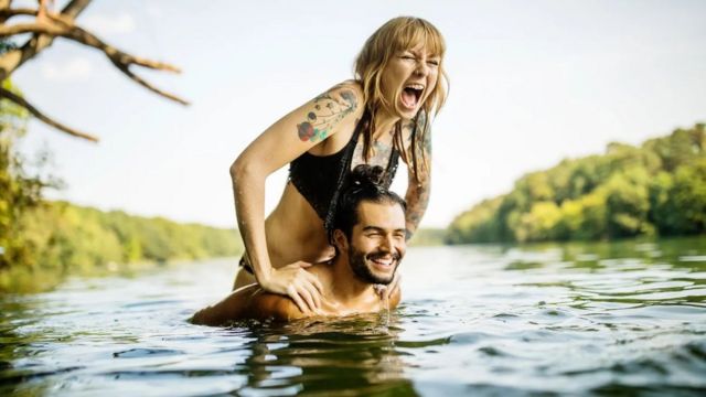 Couple have fun in river