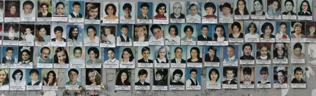 A picture made on 31 August 2005 shows portraits on the wall of school #1 of some of the victims of the Beslan crisis that erupted on 1 September, 2004