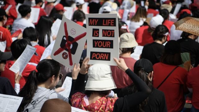Female protesters call for South Korea's government to crack down on widespread spycam porn crimes during a rally in Seoul