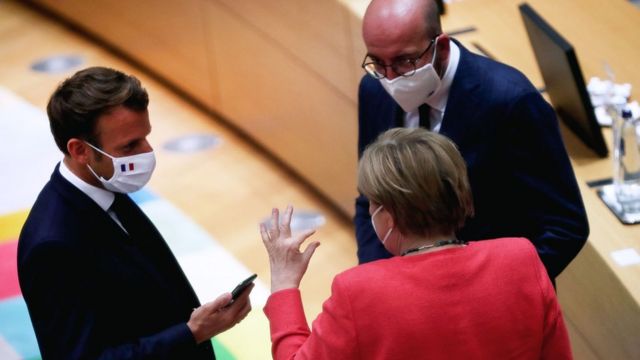 German Chancellor Angela Merkel speaks with French President Emmanuel Macron and European Council President Charles Michel