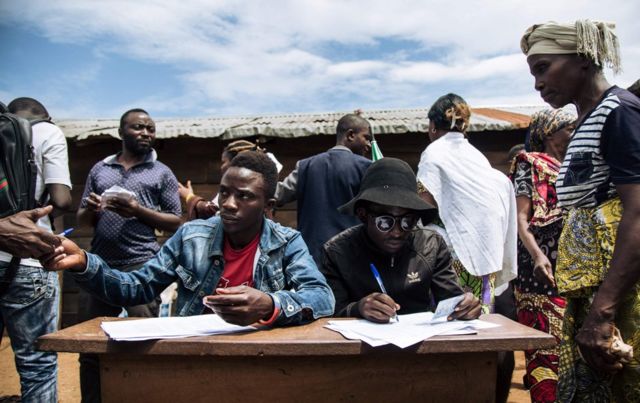 People registering voters in an improvised election in the east of the country