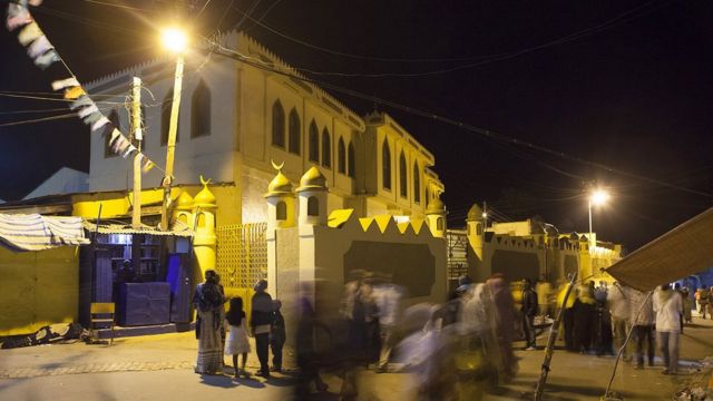 People walk in front of the Jimma Mosque, the largest mosque in Harar, especially reserved for Friday prayers, on August 3, 2014