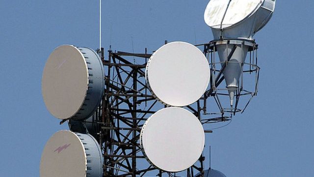Microwave transmission/reception equipment is visible atop a tower at a WorldCom in the US.