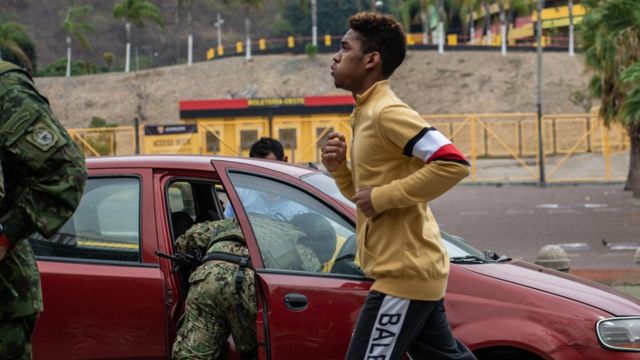 Un hombre trotando frente a una revisión militar