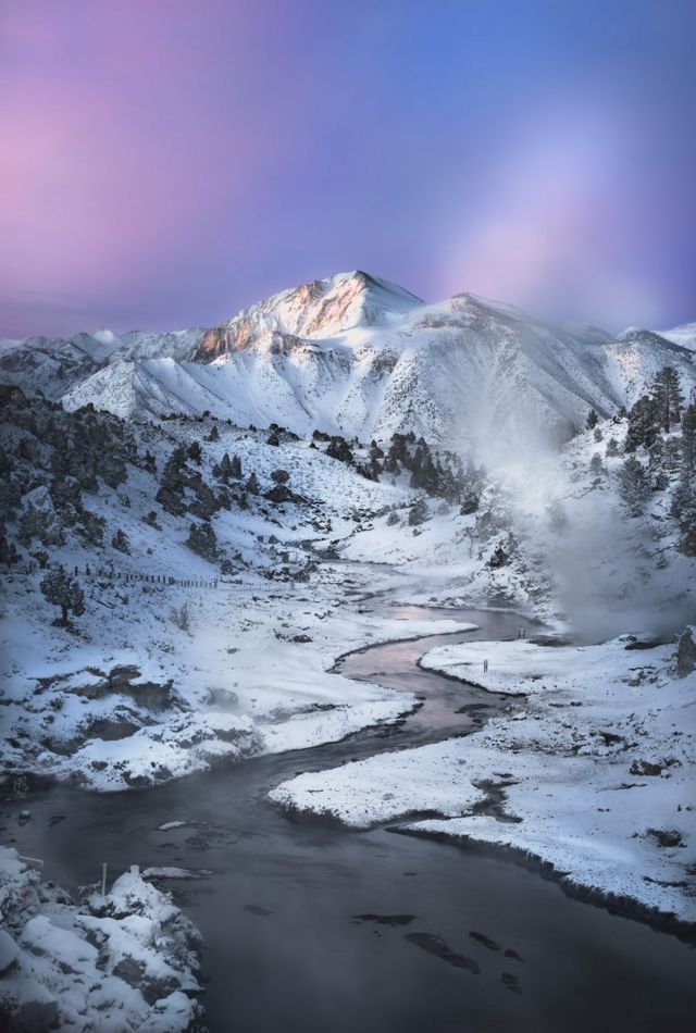 A river in front of a snow-covered mountain
