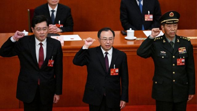 Newly-elected Chinese state councilor Qin Gang, state councilor and secretary-general of the State Council Wu Zhenglong, state councilor Li Shangfu swear an oath after they were elected during the fifth plenary session of the National People's Congress (NPC) at the Great Hall of the People in Beijing on March 12, 2023. (Photo by NOEL CELIS / AFP)