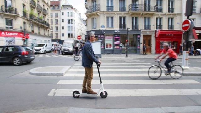 Man rides e-scooter in Paris