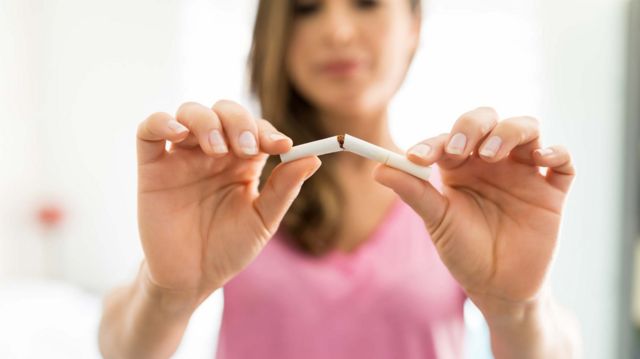 Woman breaking a cigarette