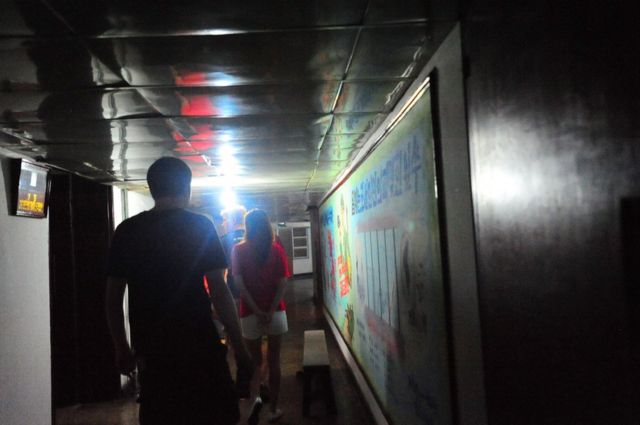 Walking down the low ceiling 5th floor corridor