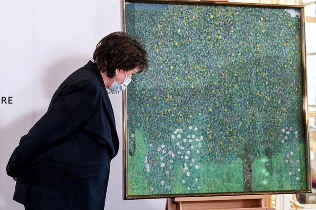 French Culture Minister Roselyne Bachelot stands next to the painting Rose Bushes under the Trees by Austrian painter Gustav Klimt, at the Musee d'Orsay in Paris, France March 15, 2021