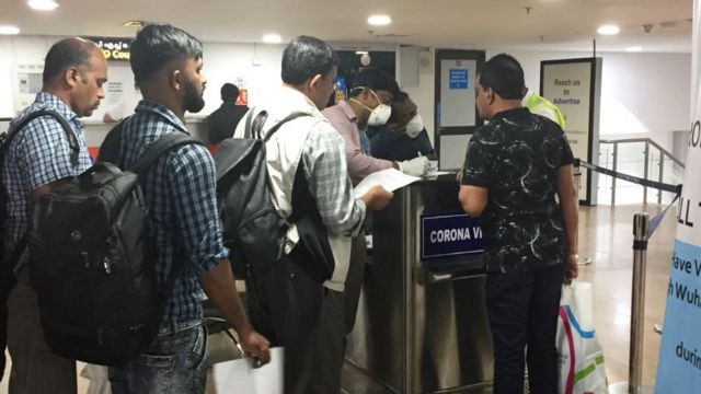 Travellers submit declarations at Trivandrum International Airport in Thiruvananthapuram, India, stating they have not recently travelled to China