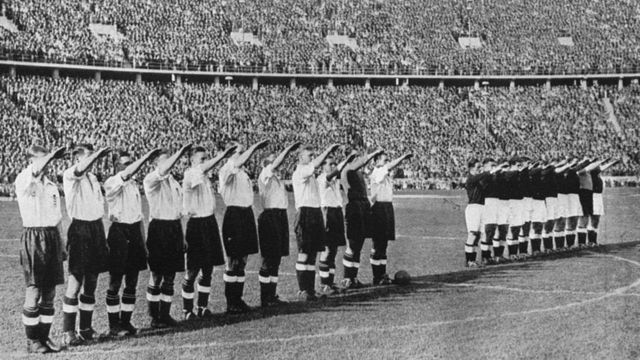 The England team, dressed in white, doing the Nazi salute in Berlin in 1938.