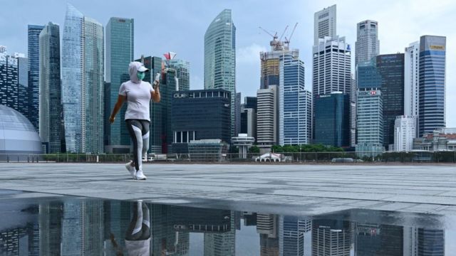 Woman walking with the Singapore skyline on the background
