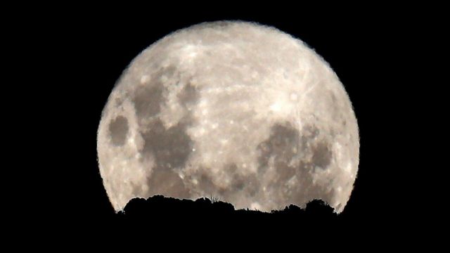 The full moon rises above the World Heritage site Table Mountain National Park in Cape Town, South Africa, 31 March 2018. This full moon was a "Blue Moon" or the second full moon in a given calendar month.
