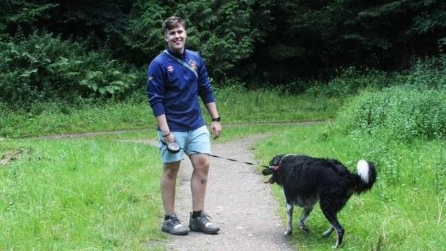 Ryan Penfold walking his black dog in the Forest of Dean