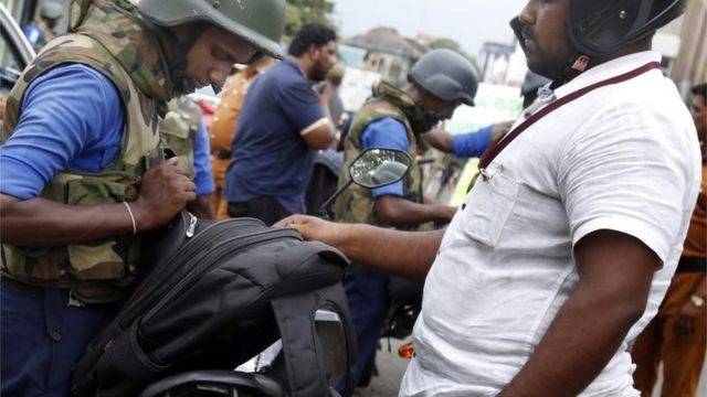 Security personnel check bags in Colombo in the aftermath of the Easter Sunday bomb attacks, 25 April 2019