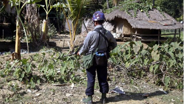 An armed policeman stands guard at the ChainKharLe village during the visit of Yanghee Lee (not in picture), the United Nations Special Rapporteur on the situation of human rights in Myanmar, Rathedaung town, Rakhine State, western Myanmar, 14 January 2017